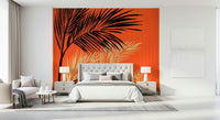 Palms at Sunset wallpaper mural of palm silhouettes on orange behind a gray upholstered bed in a bedroom