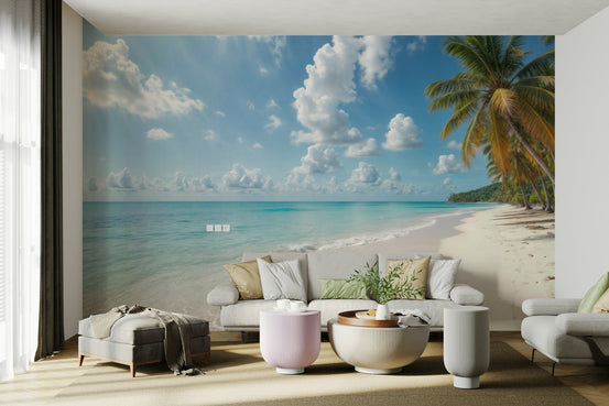 Paradise Shores wallpaper mural of a turquoise palm beach behind a white sofa and pink round tables in a living room