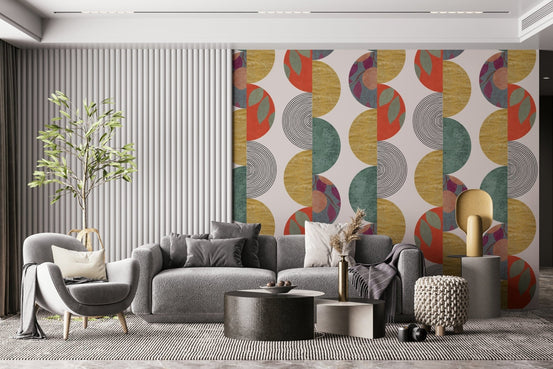 Partywall wallpaper with retro mustard and teal half-circle pattern behind a grey sofa and slatted wall panel
