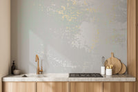 Neutral gray wallpaper with soft gold patina effect.
