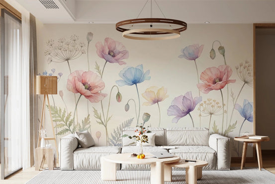 Pastel Poppy Field wallpaper mural with watercolor poppies behind a gray sofa and round wood table in a living room