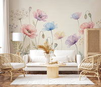 Pastel Poppy Field wallpaper mural of watercolor poppies above a white sofa flanked by rattan armchairs in a living room