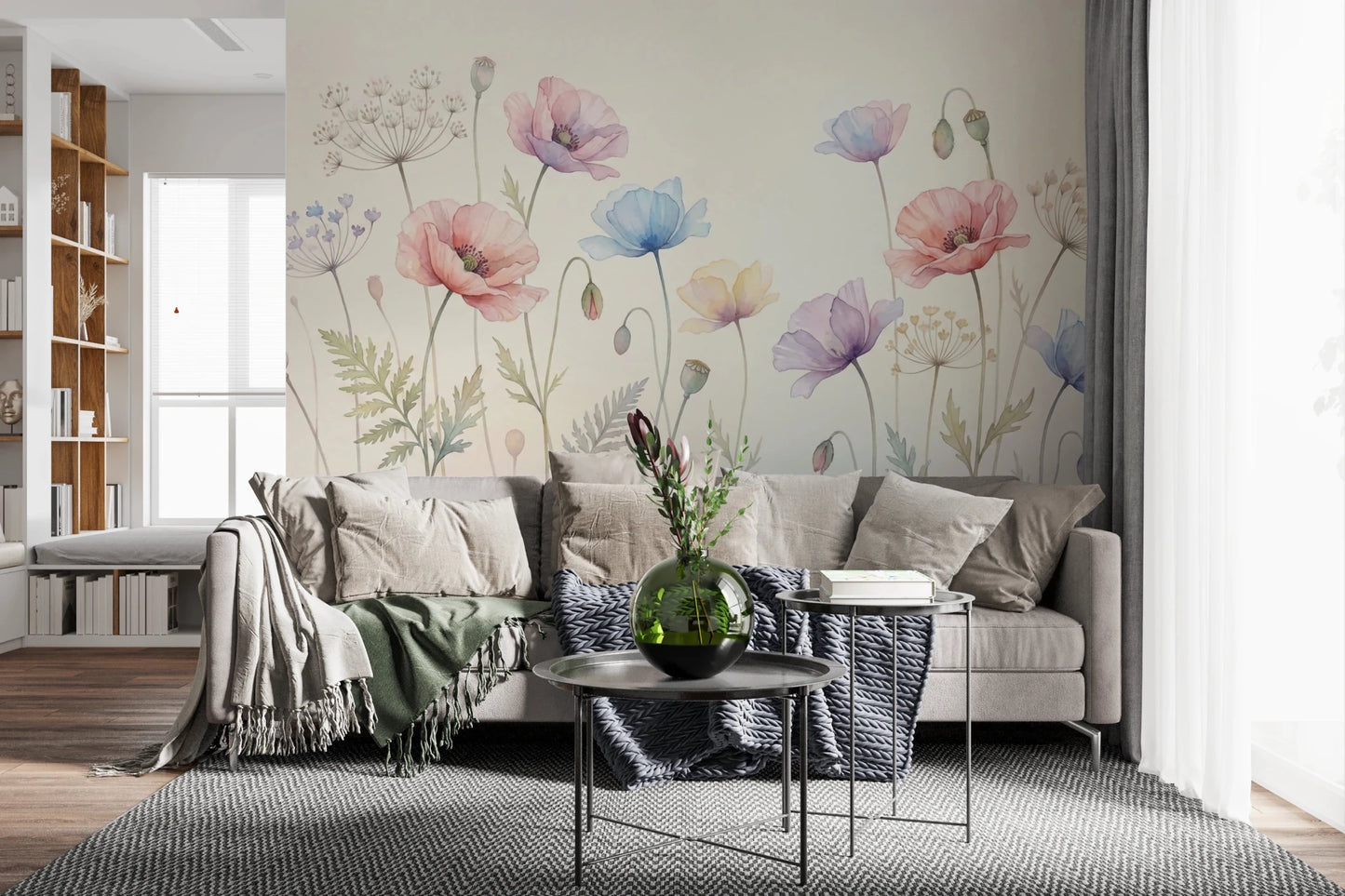 Pastel Poppy Field wallpaper mural in pink and blue behind a beige sofa with green throw in a bright living room