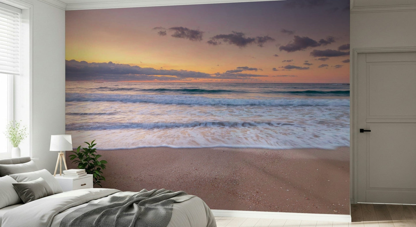 Peace at the Beach wallpaper mural of a calm sunset sea behind a white bed with a grey throw in a bedroom