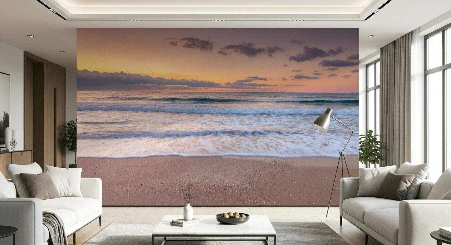 Peace at the Beach wallpaper mural of orange dusk waves in a living room with two white sofas and a floor lamp
