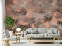 Subtle Canvas wallpaper mural of painterly peach tones behind a grey sofa and wood armchair in a living room