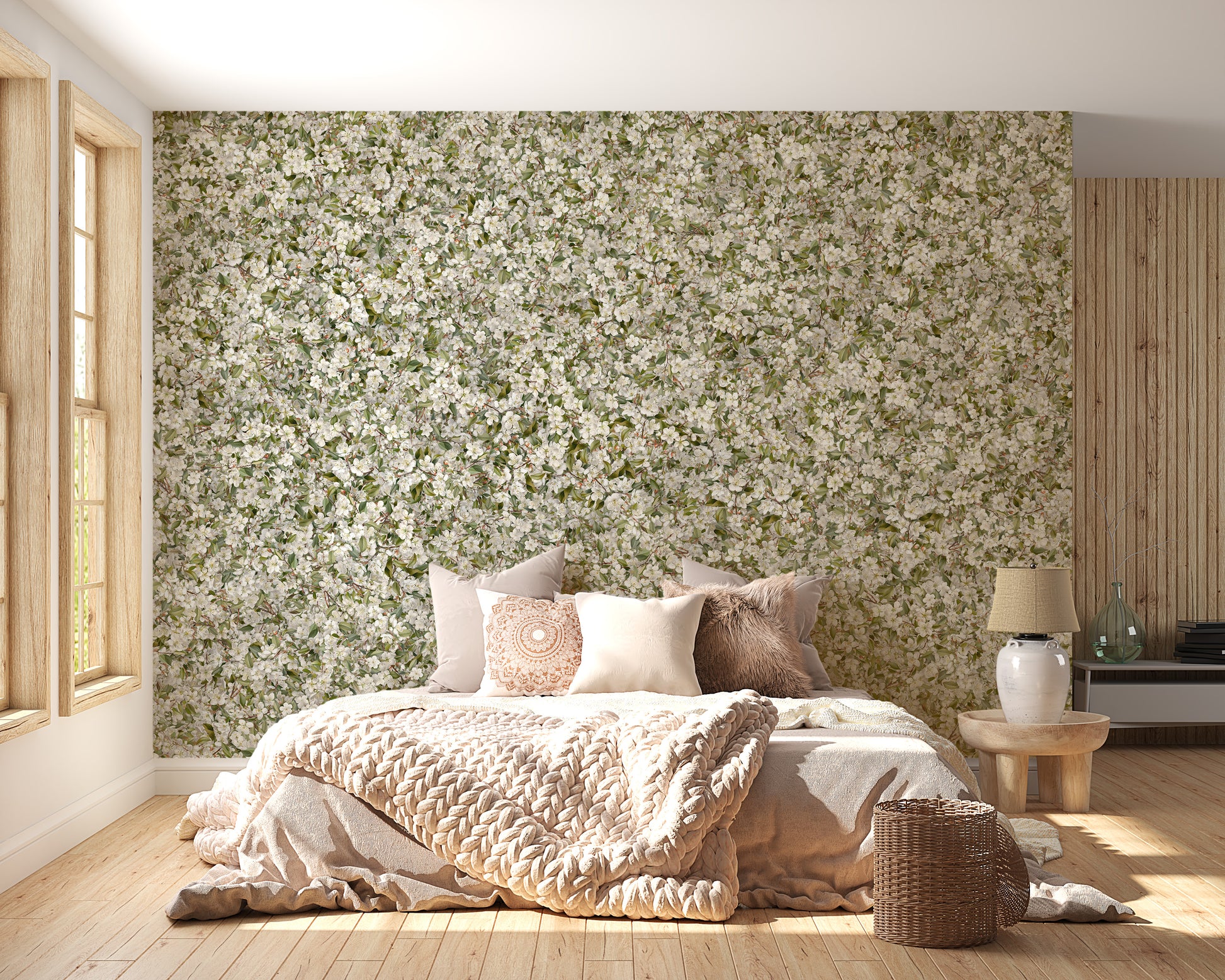 Pear Blossom White Flowers wallpaper mural above a bed with blush bedding in a warm wood-floored bedroom