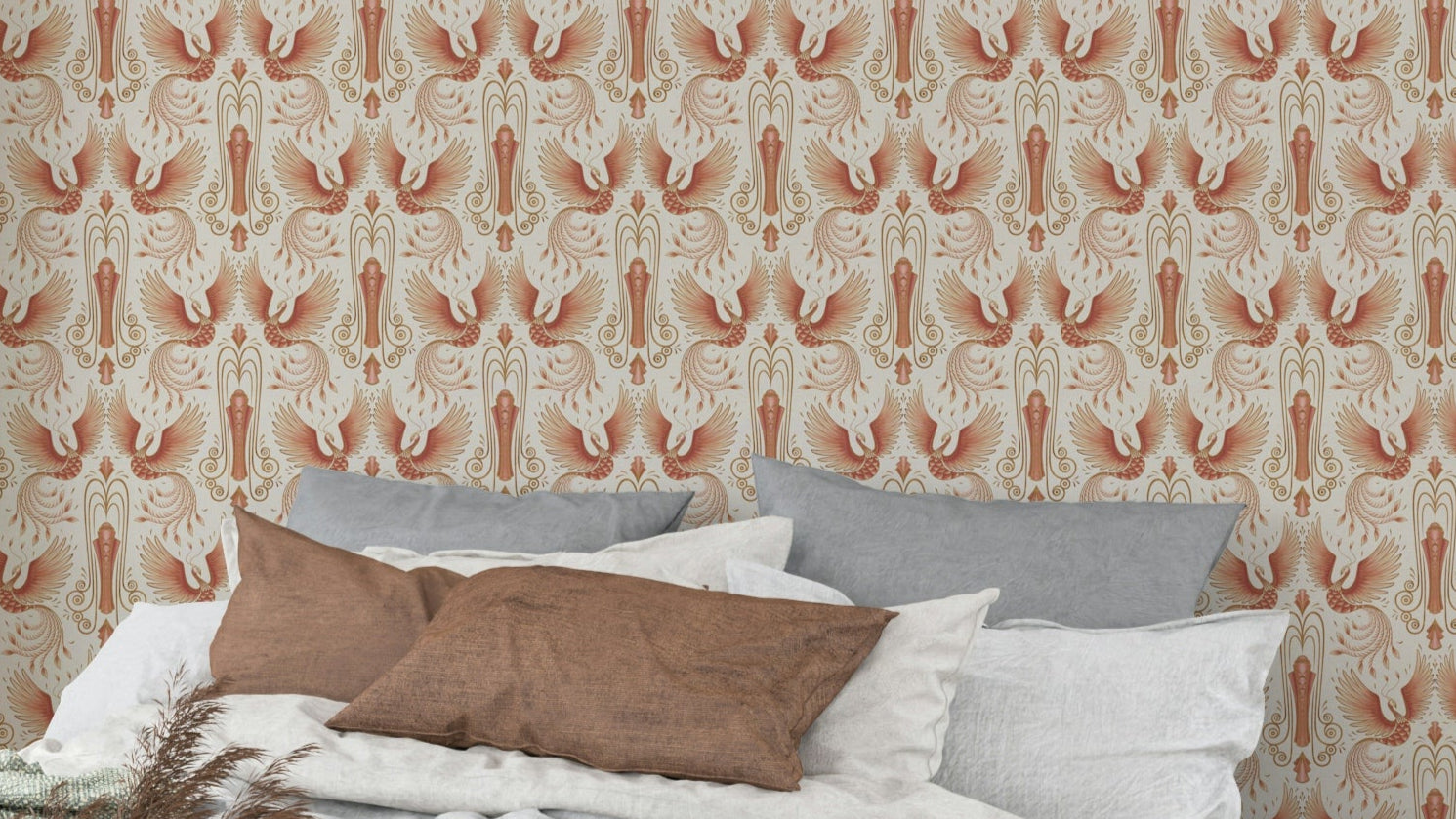 Rebirth of a Phoenix Light Blush wallpaper with peach birds on cream behind a bed with grey and brown pillows
