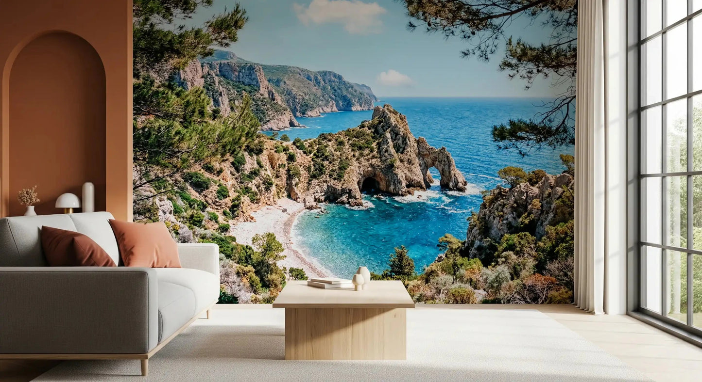 Mediterranean coast wall mural showing rocky arches, pines, and bright blue sea