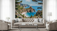 Coastal wall mural in a living room with pine trees, azure sea, and rocky cove