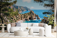 Pine-Framed Azure Coast wall mural with turquoise water and sunlit cliffside