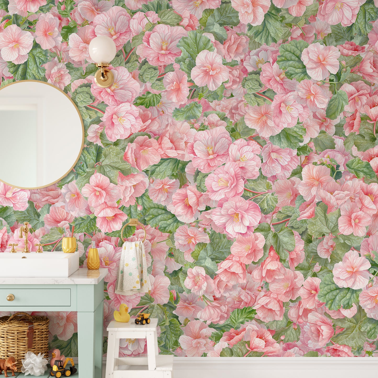 Pink Begonia Flower wallpaper mural in a bathroom with a round mirror, green vanity and a kids step stool