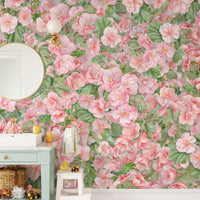 Pink Begonia Flower wallpaper mural in a bathroom with a round mirror, green vanity and a kids step stool