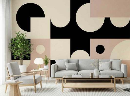 Pink Black Bold Geometric Interplay wall mural behind a grey sofa and wood armchair with a mushroom lamp