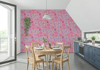 Home office desk set against a vibrant red and lavender floral tile print wall.
