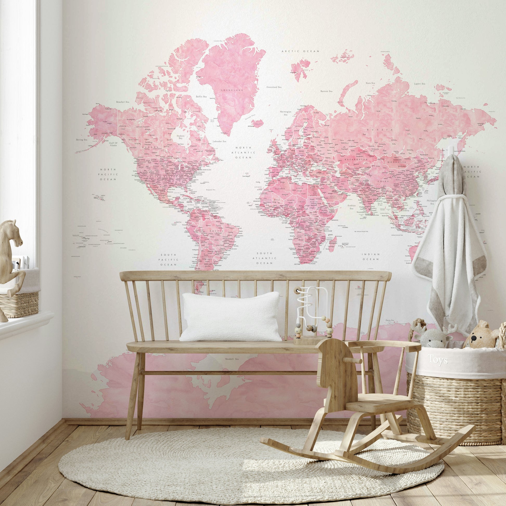 Gentle pink world map mural for nurseries

