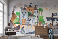 Pirate Fortress wall mural with skull flags and a galleon behind a grey armchair and wooden dresser in a playroom