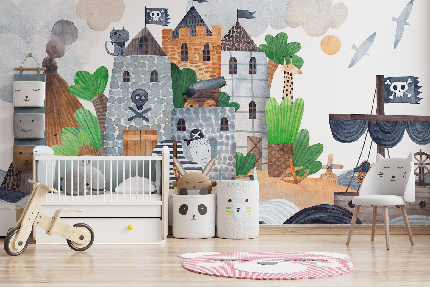 Pirate Fortress wall mural in a nursery with a white crib, wooden balance bike and panda storage bins