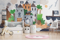 Pirate Fortress wall mural in a nursery with a white crib, wooden balance bike and panda storage bins