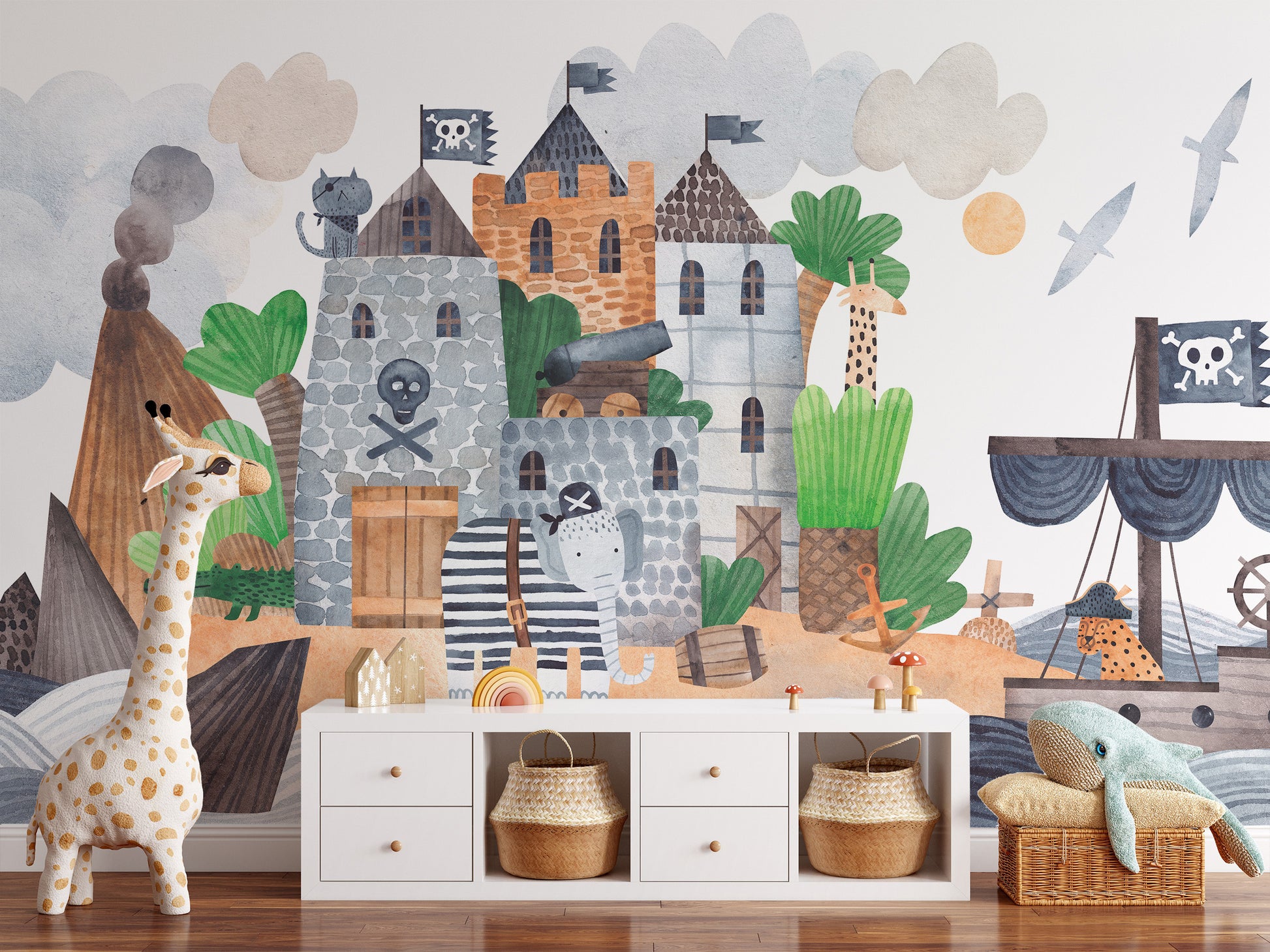 Pirate Fortress wall mural in watercolor blues and tan over a white sideboard with woven baskets and a plush giraffe