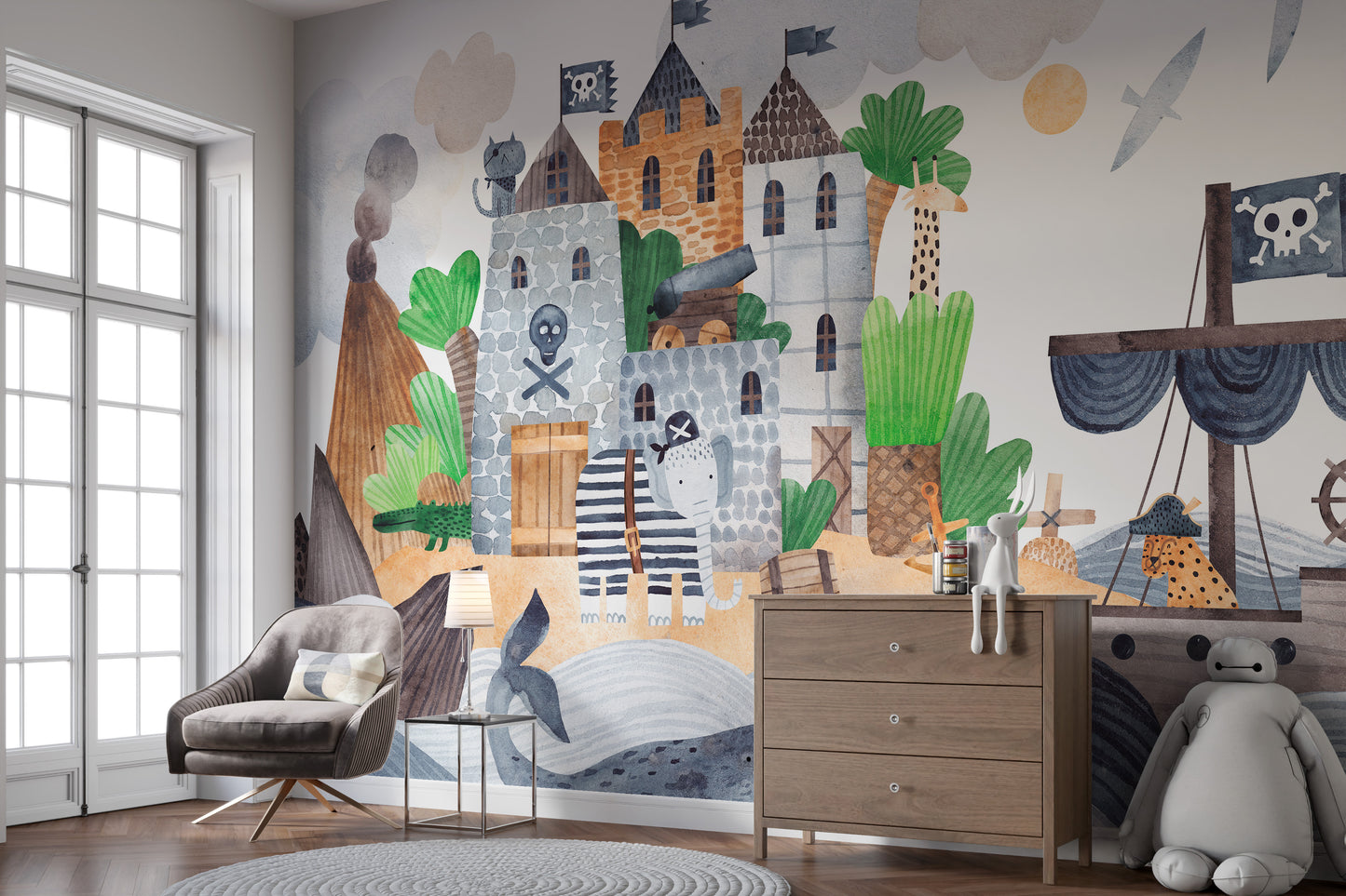 Pirate Fortress wall mural with a stone castle and pirate ship behind a grey armchair and wooden dresser in a child's room