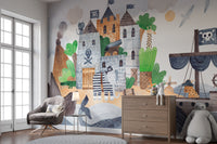 Pirate Fortress wall mural with a stone castle and pirate ship behind a grey armchair and wooden dresser in a child's room