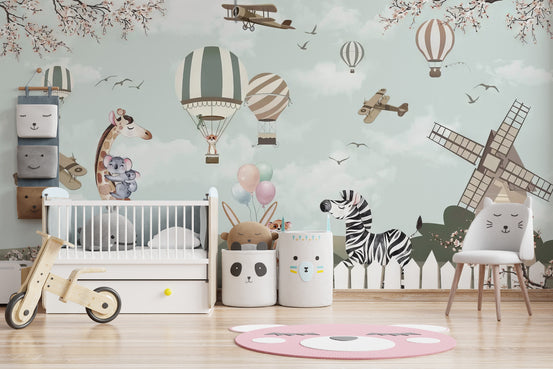 Playful Animal Nursery wallpaper with giraffe, zebra and hot air balloons above a white crib in a soft green nursery