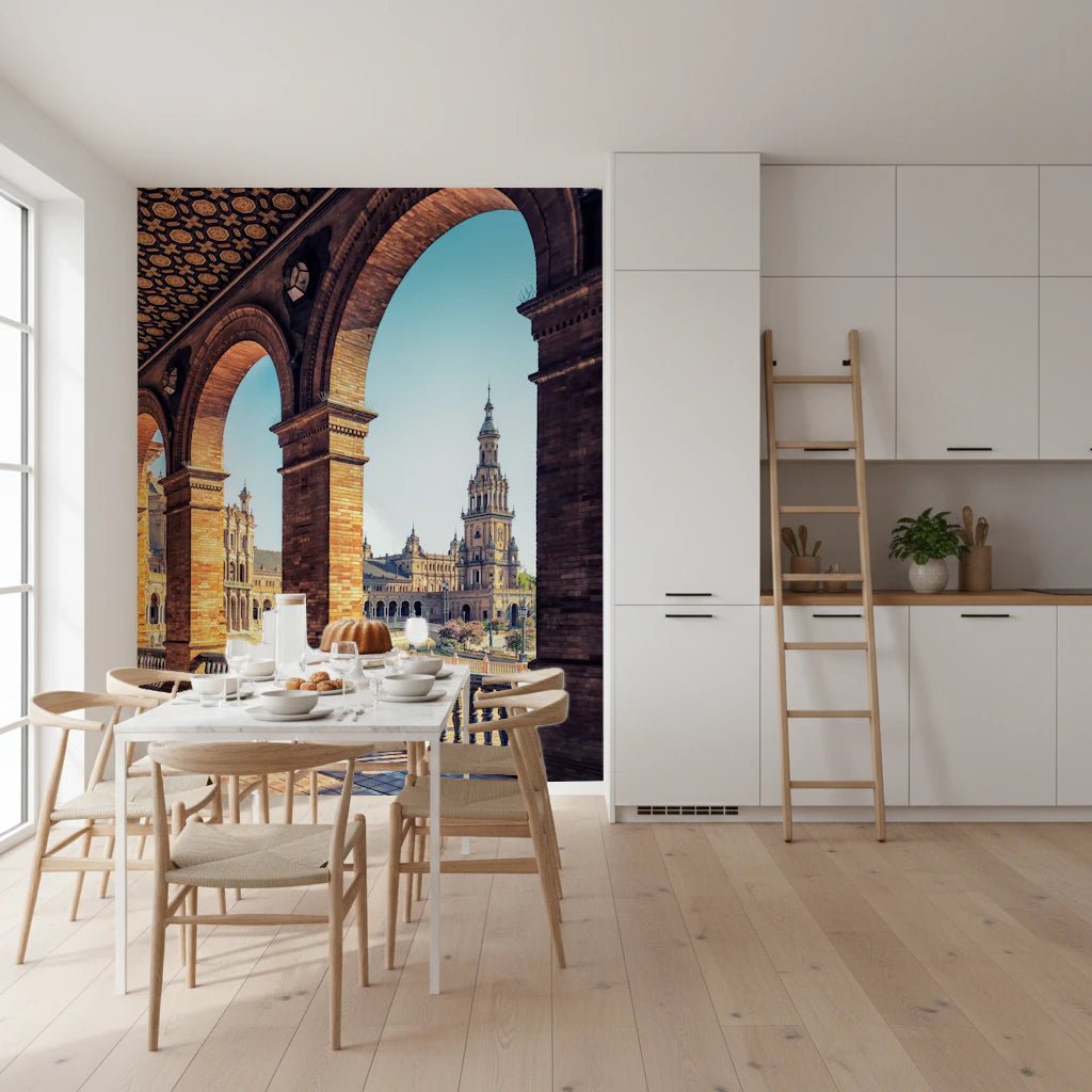 Plaza de España View wallpaper mural of Seville brick arches and tower behind a white dining table in a bright kitchen