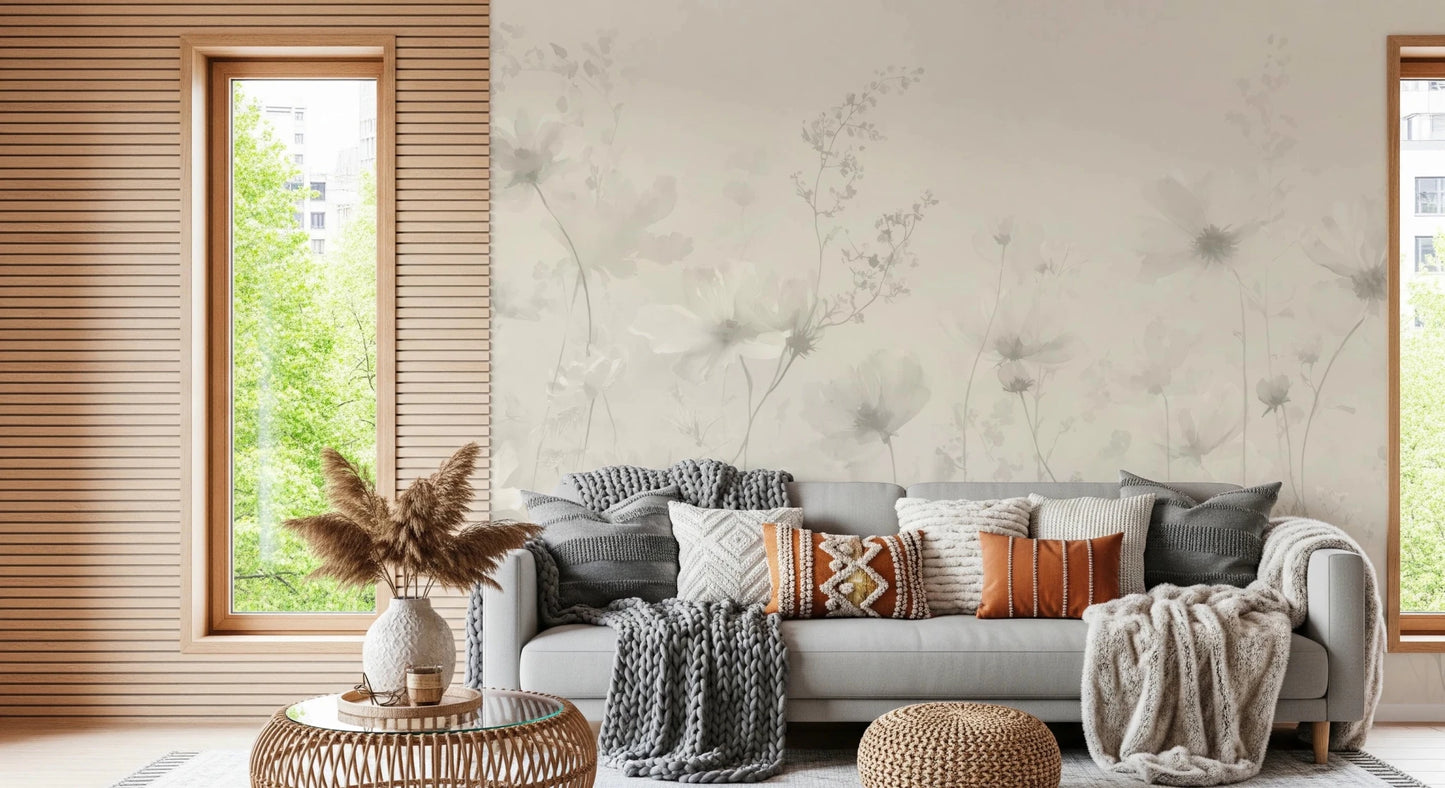 Poetic Soft Floral Linen wallpaper mural of greige flowers in a living room with a grey sofa and rust knit pillows