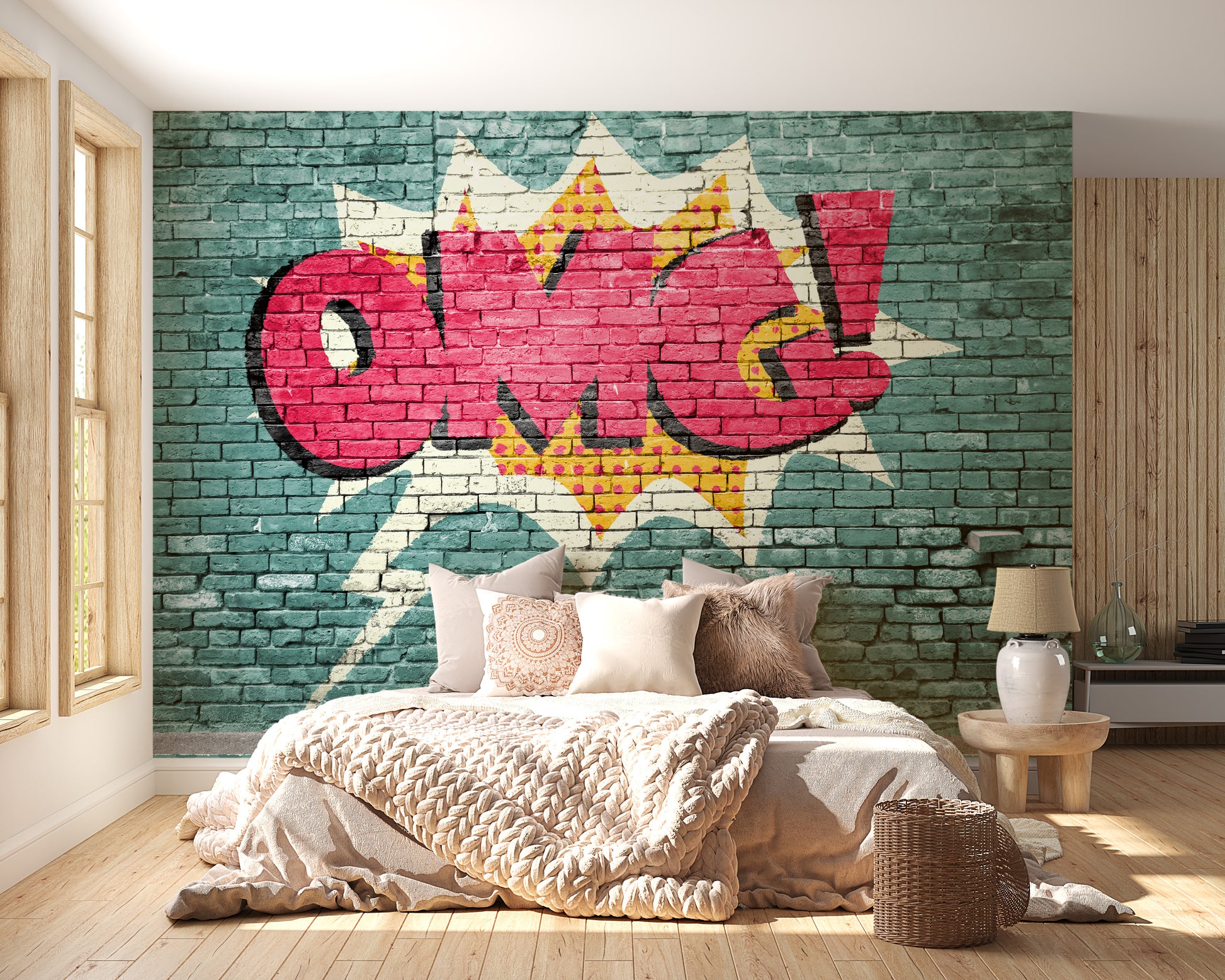 Pop Art OMG Graffiti wallpaper mural on teal brick behind a bed with cream knit bedding in a bright bedroom