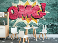 Pop Art OMG Graffiti wallpaper mural on teal brick in a kids room with white bunny chairs and a play kitchen