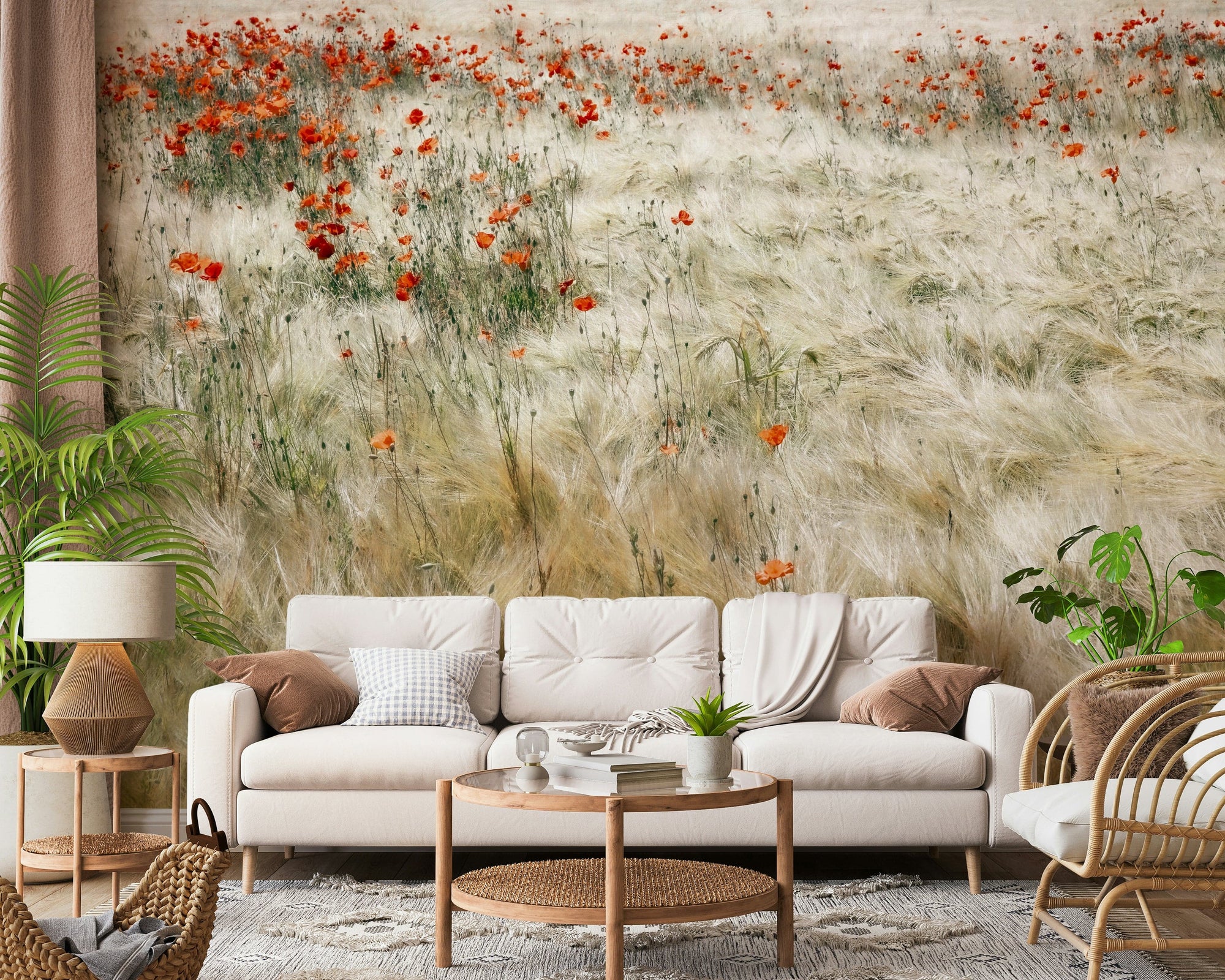 Poppy Field Dreams wallpaper mural of red poppies in a pale grass field behind a cream sofa and rattan chair