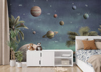 Pretty Planets wallpaper mural with Saturn and planets beside a white bed and sideboard in a kids bedroom