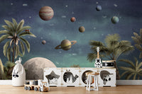 Pretty Planets wallpaper mural with planets and the moon above a white toy cabinet in a kids room