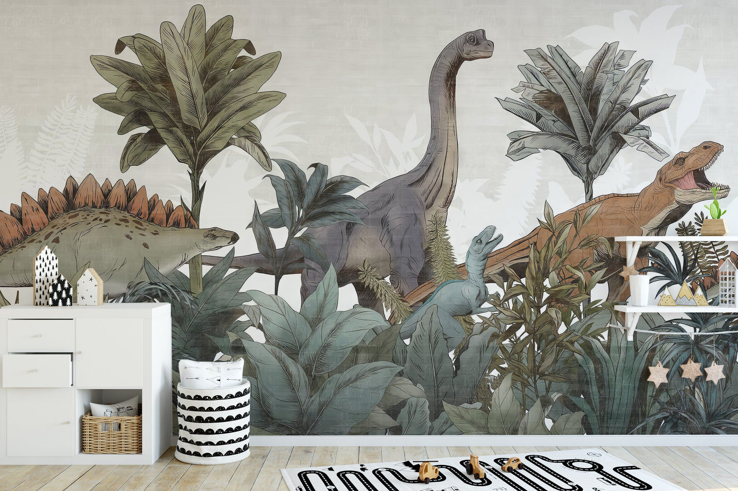 Jurassic Journey wallpaper mural of dinosaurs among ferns behind a white sideboard and striped basket in a kids room