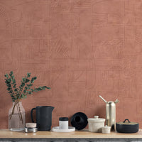 Mystic Terracotta wallpaper mural close-up showing the etched abstract pattern detail behind eucalyptus and ceramic vessels