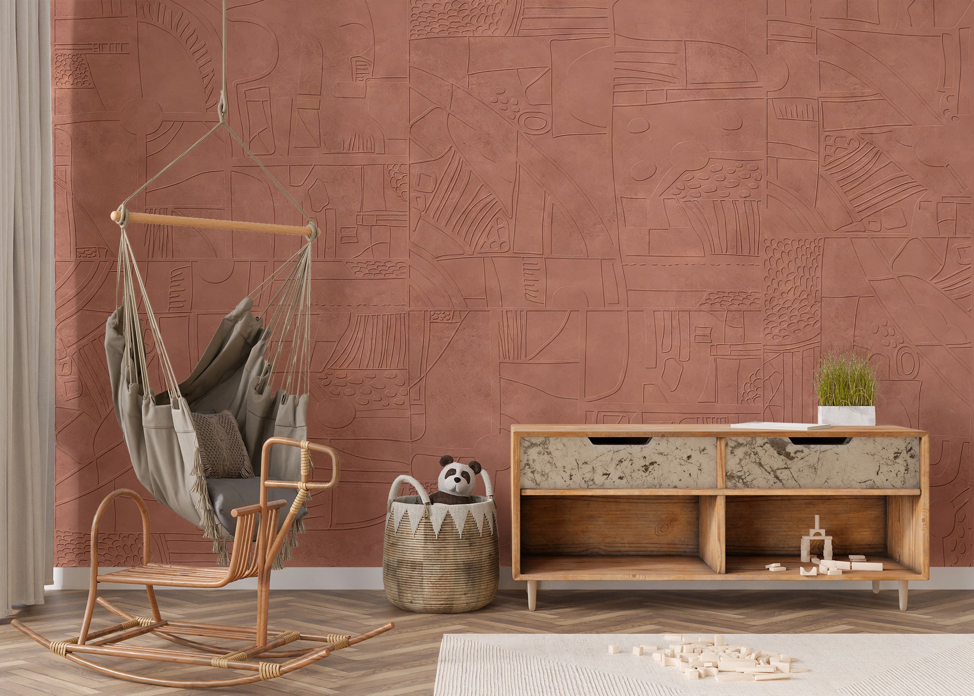 Mystic Terracotta wallpaper mural in warm clay tones behind a rattan hanging swing chair and wood credenza in a living room