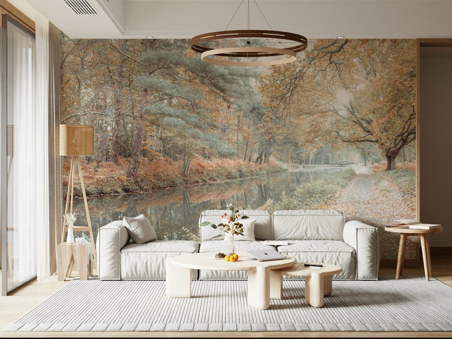 Wallpaper featuring a tranquil forest path beside a calm reflective river in soft autumn tones.