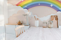 Colorful Rainbow wallpaper mural styled as a feature wall behind a dining table and chairs in a multicolour palette