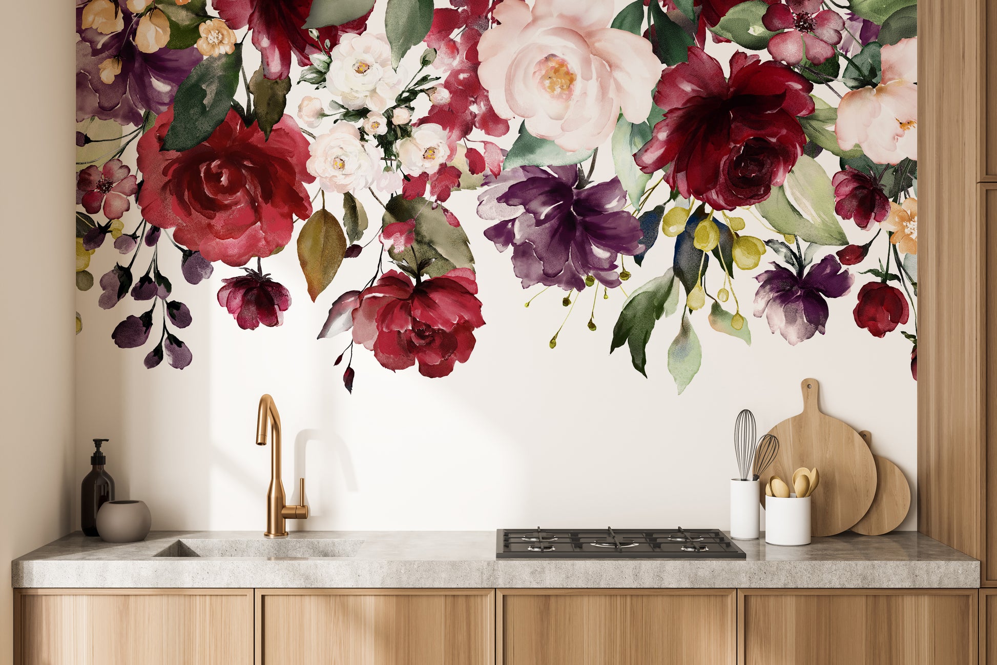 Red and Pink Floral wallpaper mural of roses above wood cabinets and a gold faucet in a kitchen