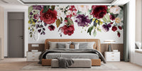 Red and Pink Floral wallpaper mural of hanging blooms above a tan leather bed in a bedroom