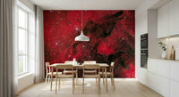 Cosmic Ember wallpaper mural in red nebula tones on a kitchen dining wall with wood table and pendant light