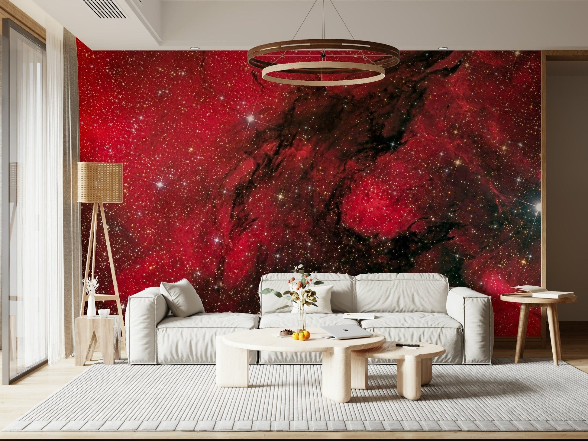 Cosmic Ember wallpaper mural of red galaxy and stars behind a white sofa with ring chandelier in a living room
