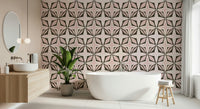 Modern wall mural, dark brown shapes on a subtle pink background.