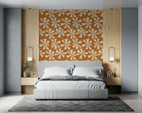Retro-style wallpaper with bold pinwheel flower motifs in warm earthy tones.