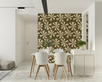 Geometric starburst wallpaper with scattered retro flower shapes in muted earthy tones.