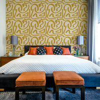 Mid-century abstract mustard brush wallpaper in living room

