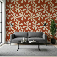 Decorative wallpaper with playful cream pinwheel shapes arranged across a warm terracotta tone.