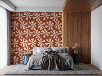 Vintage starburst pattern wallpaper with radiating cream petals on a textured terracotta backdrop.