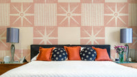 Retro starburst quilt block pattern in pink tones

